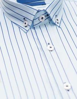 striped shirt with a focus on the collar and button, close-up