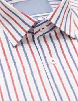 striped shirt with a focus on the collar and button, close-up