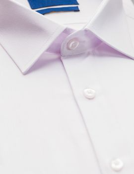 white shirt with focus on collar and button, close-up