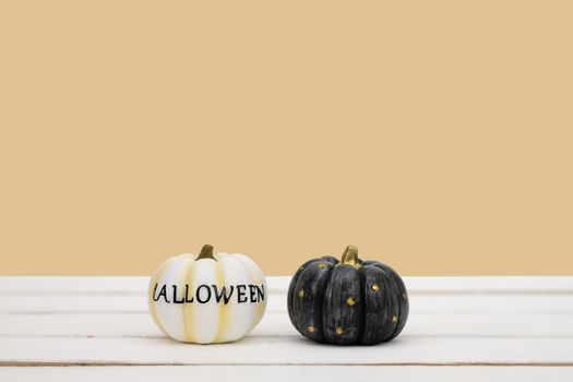 Halloween pumpkin on yellow background. Halloween idea minimal concept.