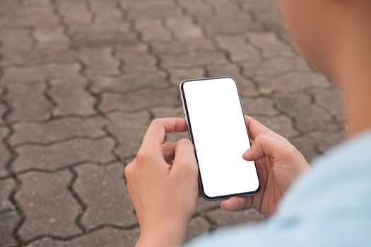 Hand's young hipster woman using smart phone on brick road.