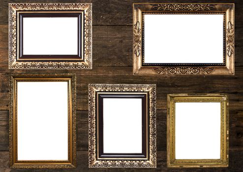 Group of Old Gold Picture Frames on wooden wall