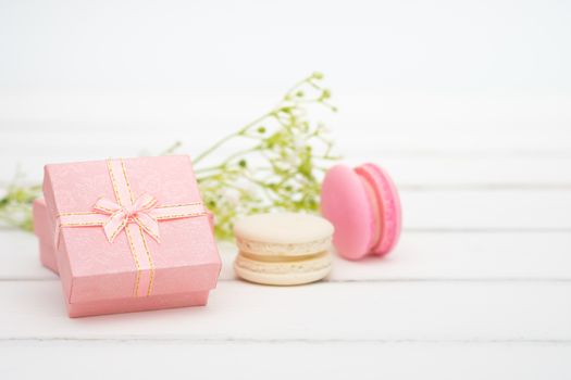 Gift box and macarons on whie table background with copy space to write.