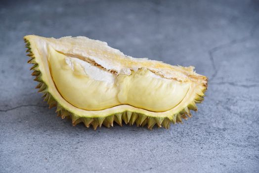 Durian riped. King of Fruits. Durian is a popular tropical fruit in Thailand. Betel of durian with durian peel on Dark color background. Seasonal fruit concept. Selected focus.
