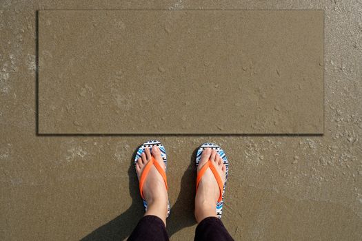 Women wear orange sandals, which stands on the beach . Including billboards for adding text to advertise.