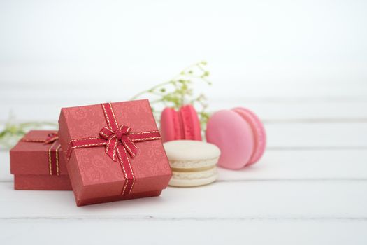 Gift box and macarons on whie table background with copy space to write.