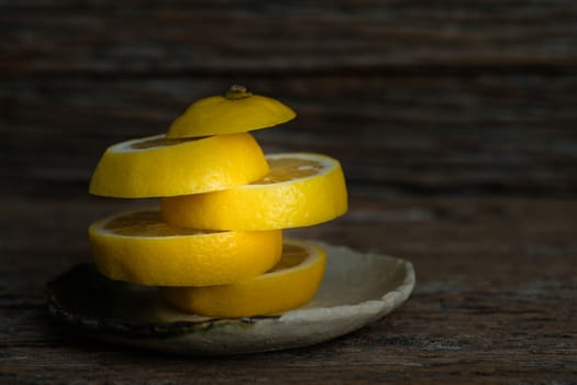 Still life with lemons on rustic low key background, Choose focal point, dark light style.