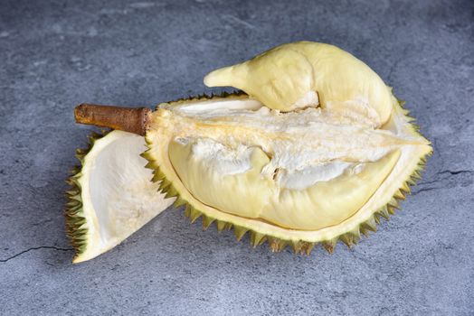 Top view Durian riped. King of Fruits. Durian is a popular tropical fruit in Thailand. Betel of durian with durian peel on Dark color background. Seasonal fruit concept. Selected focus.