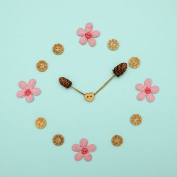 Clock made of flowers at 10.00 on blue background, The concept of time.