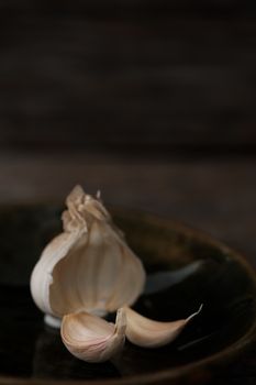 Still life of garlic bulb in dark black background with copy space, It is a herbal food popular Asian.