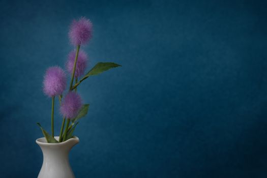 Still life with flower in the ceramic vase on rustic blue background, Choose a focal point, copy space for write.