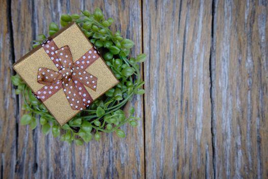 Gift box with as a present for Christmas, new year, valentine day or anniversary on wooden background, top view, space for write.