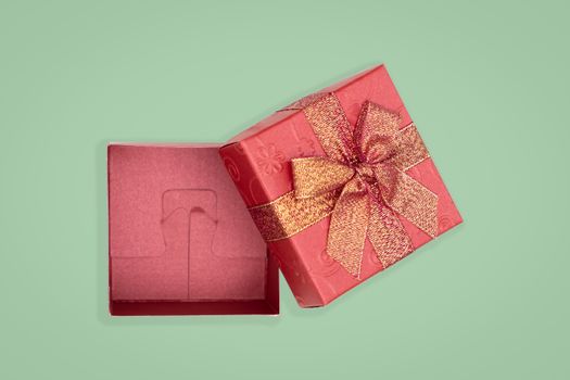 Top view of opened red gift box on green background. with copy space for text.