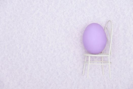 Egg shell on purple background. Minimal and easter concept, with copy space to write.