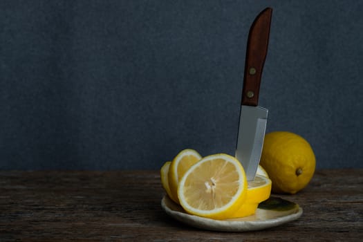 Still life with lemons on rustic low key background, Choose focal point, dark light style.