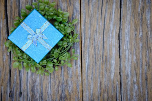 Gift box with as a present for Christmas, new year, valentine day or anniversary on wooden background, top view, space for write.