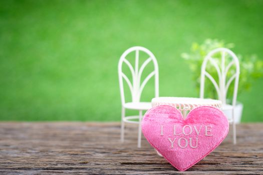 Pot plants and mini shape-heart on a wooden floor in green garden background for valentine day, AF point selection, with space for write.