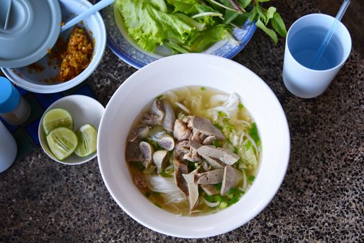 Top view Khanom Chin Nam Ngeaw, Rice noodles or Thai North East local noodle made from fermented rice flour with pork soup. Delicious local food for sell at Chiang Khan Thailand only. Selected focus