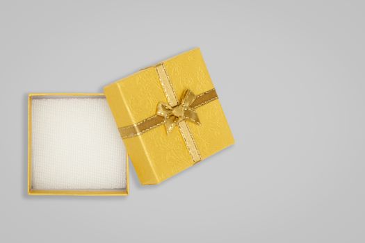 Top view of opened yellow gift box on glay background. with copy space for text.