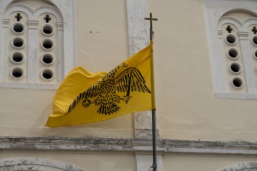 Double-headed flag on St George Orthodox church in old town in the city of Nafplio in Greece