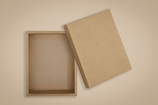 Opened cardboard box on a brown background.