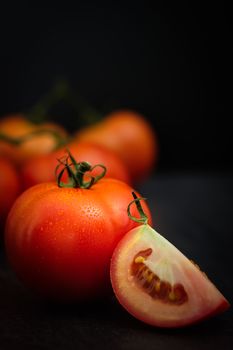 Still life of fresh ripe tomatoes on wooden background, Choose focus point. Good health concept.  Vertical picture style.