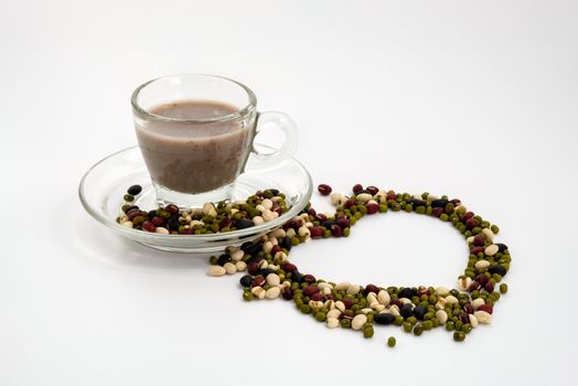 Milk from five kinds of beans isolated on white background, Sprinkle nuts into a heart shape.