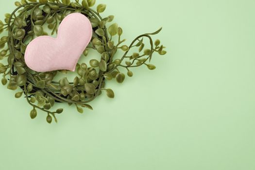 bouquet of leaves and heart shape on green background with valentine concept.
