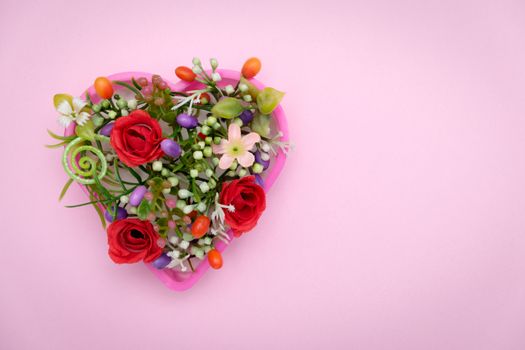 The flowers are in a heart shaped pot, valentine concept.