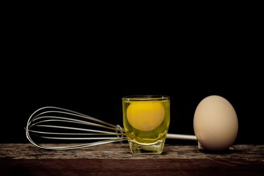 Still life-Eggs and yolks in glass arranged in a black scene, Egg is beneficial to the body, Food concept. dark tone.