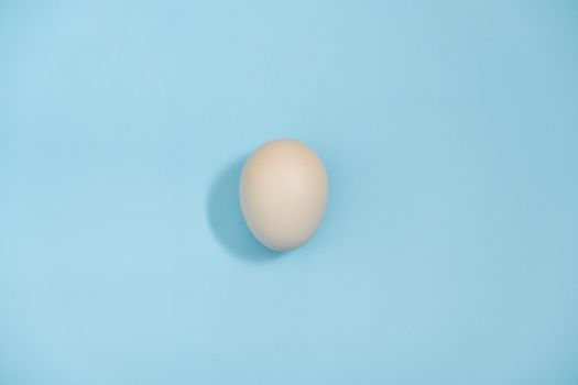 Top view - An Egg isolated on blue background, Eggs is beneficial to the body, Food concept.