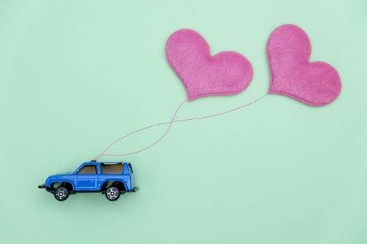 Toy car carrying heart-shape balloon, Concept of valentine day.