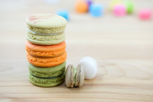Sweet and colorful macaroon cookies tower on wooden background with blank space,selective focus, Dessert.
