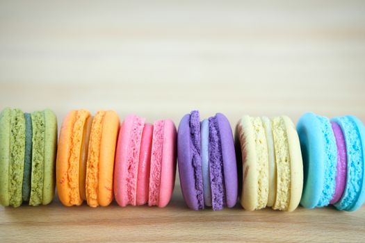 Sweet and colorful, Different kinds of macaroons in stack on light wooden background with blank space,selective focus, Dessert.
