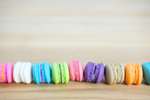 Sweet and colorful, Different kinds of macaroons in stack on light wooden background with blank space,selective focus, Dessert.