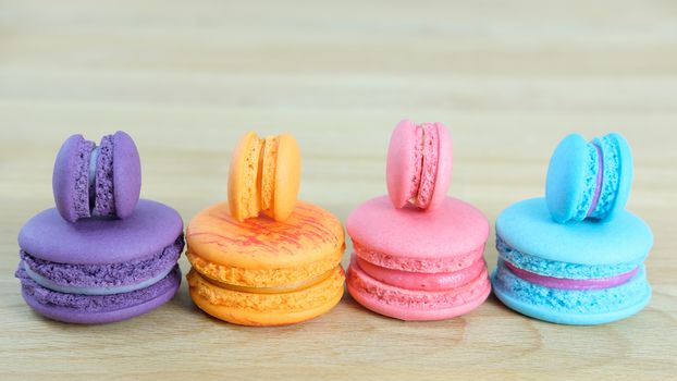 Sweet and colorful, Different kinds of macaroons on light wooden background with blank space,selective focus, Dessert.