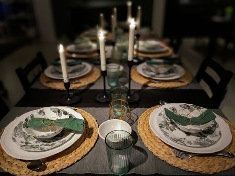 Dinner table setting by candlelight, Christmas Family Dinner Concept.