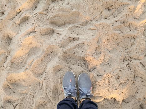 Top view of shoes on tropical sand beach.