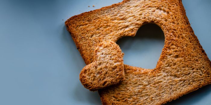 Love Concept. Burned Sliced Toasted Bread with a shape of Heart Lay on Table