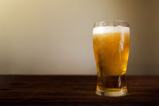 Glass of Beer on Wooden Table. Front View. Shot with Natural Daylight