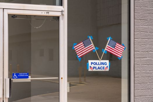 USA flags stuck to window of Polling place for early voting in the USA elections