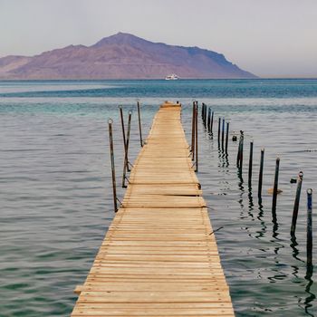 Old wooden pier on the Red sea at overcast day