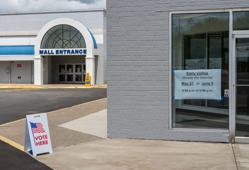 USA flags stuck to window of Polling place for early voting in the USA elections