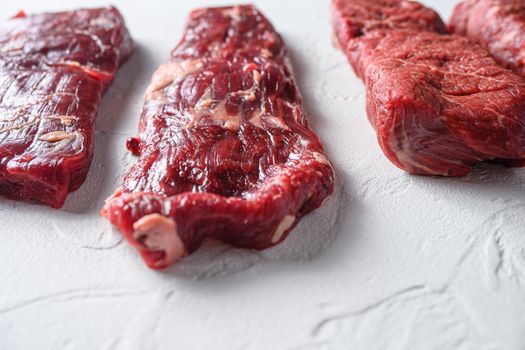 Alternative machete fajita steak organic meat cut side view close up over white concrete background.