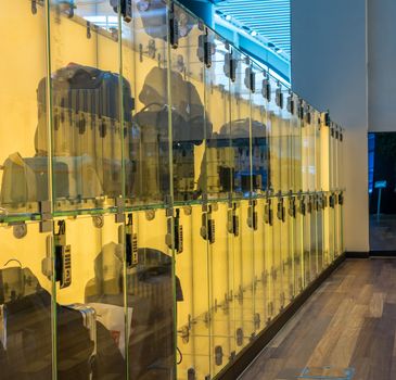 Modern luggage storage solution in airport with glass boxes for carry-on bags