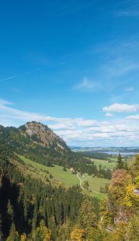 Beautiful nature of European Alps, landscape view of alpine mountains, lake and village on a sunny day, travel and destination scenery