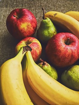 Organic apples, pears and bananas on rustic linen background, fruits farming and agriculture