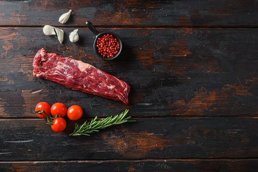 Organic machete steak or hanging tende cut, with rosemary over wood background Top view space for text.