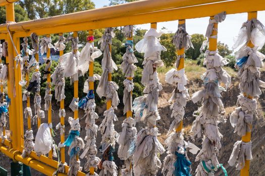 Tied cloths and plastic bags expressing love on bridge over Corinth Canal near Athens