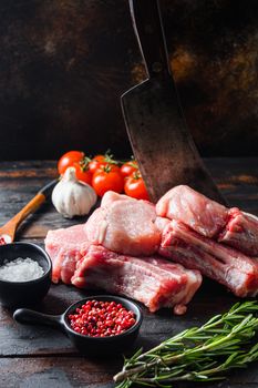 Fresh raw pork meat from organic farm with spices: pepper, salt, bay leaf. over rustic wood and metal Food background side view close up